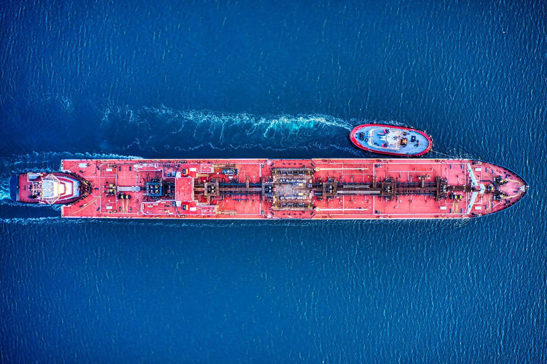 Aerial Shot Of A Red Cargo Ship At Sea Background