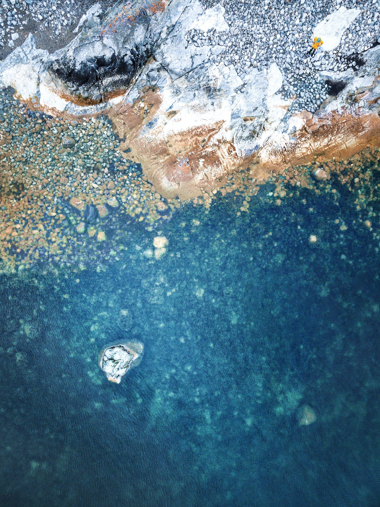 Aerial Shot Of Ocean Near A Cliff Ios 12 Background