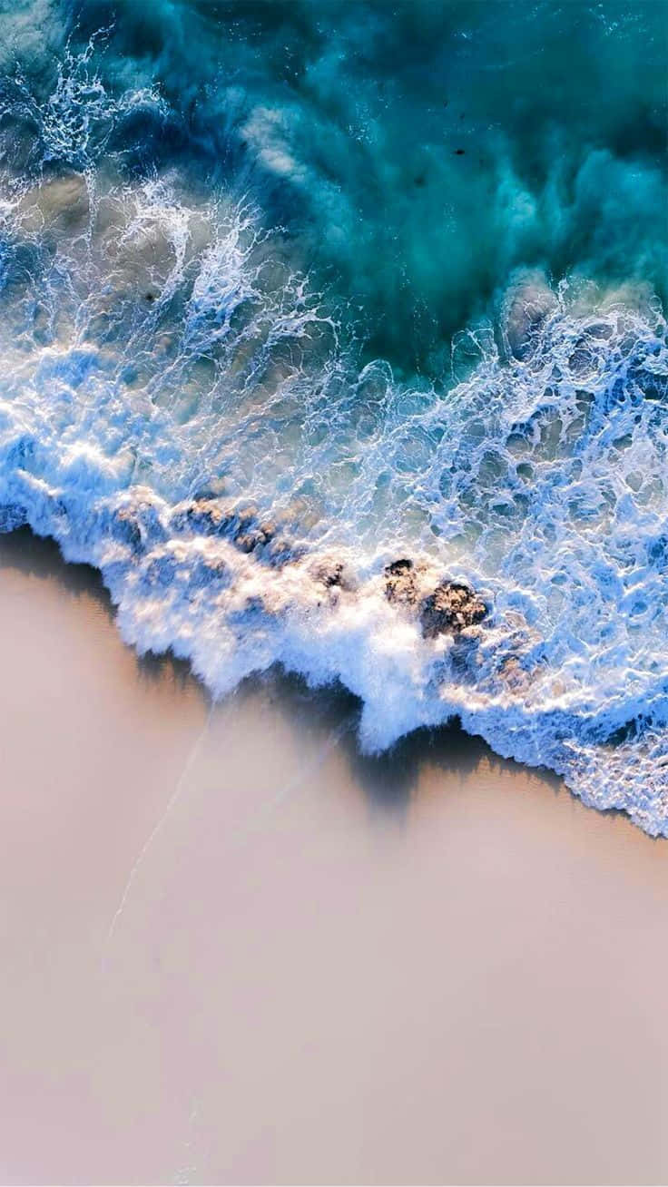 Aerial_ View_ Crystal_ Clear_ Waves_ Crashing_ Shoreline.jpg Background