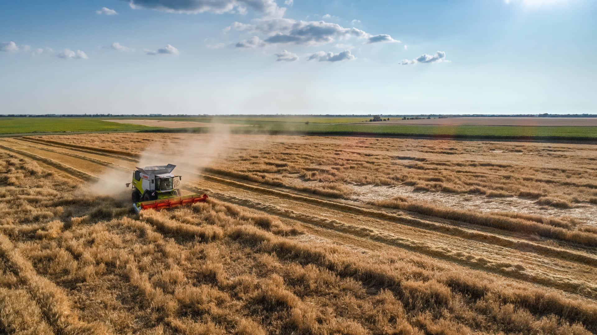 Aerial View Of A Combine Harvester In A Field Background