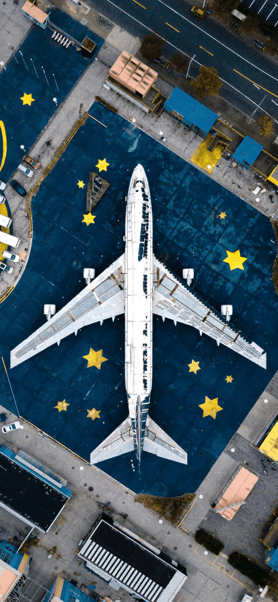 Aerial_ View_of_ Aircraft_at_ Gate_with_ Stars Background