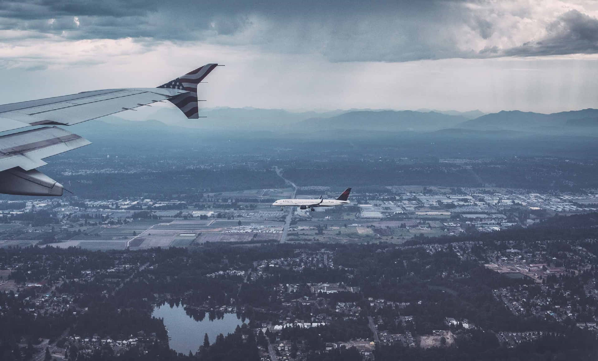 Aerial_ View_of_ Airplane_ Wing_and_ Second_ Aircraft_ Mid_ Flight Background