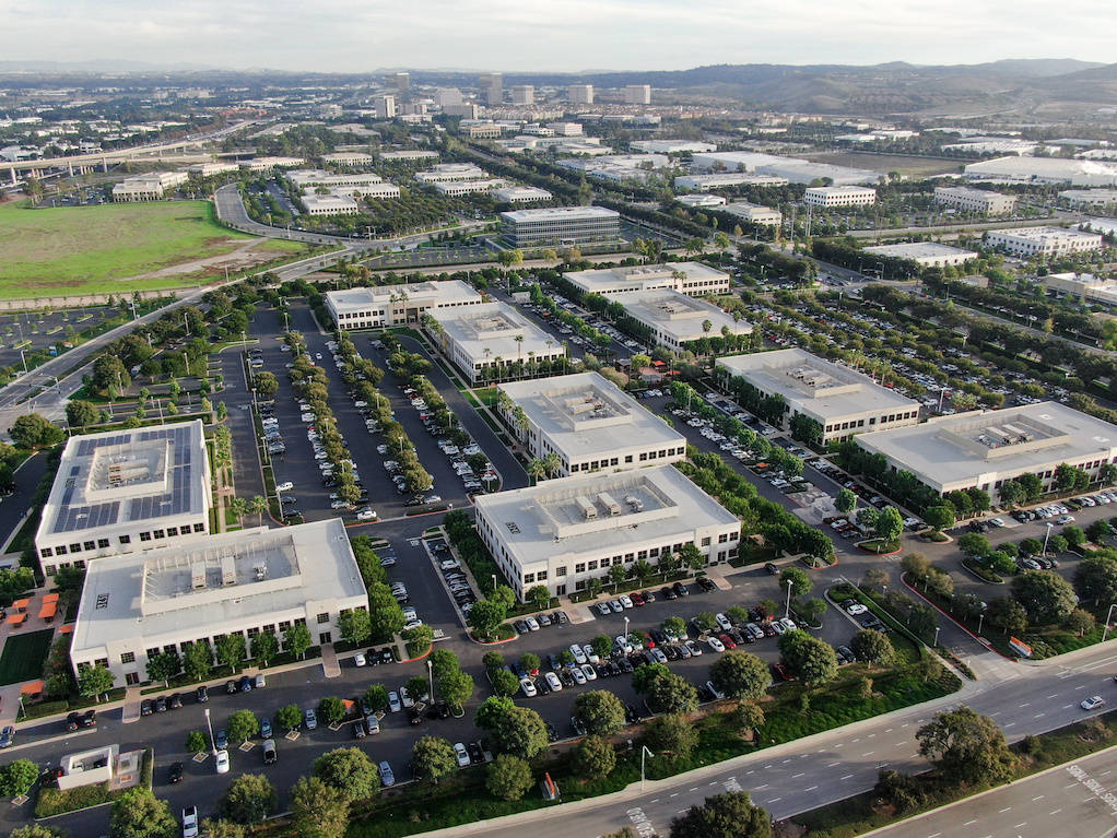 Aerial View Of Buildings With Parking Lots Background