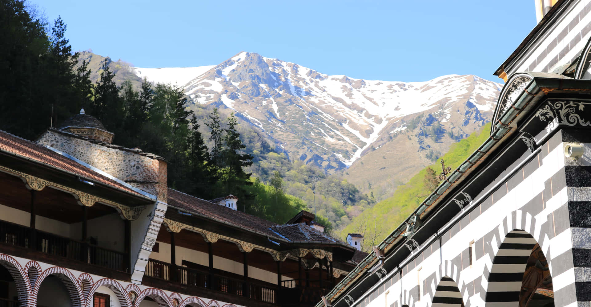 Aerial View Of Rila Monastery Amidst Snow-capped Mountains