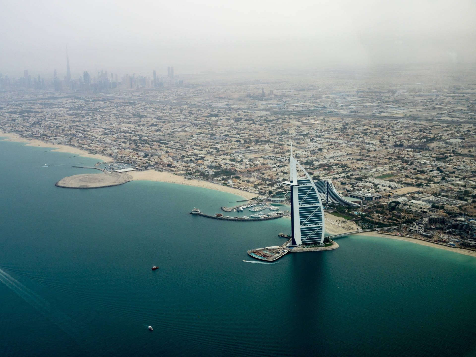 Aerial View Of The Spectacular Burj Al Arab In Dubai Background