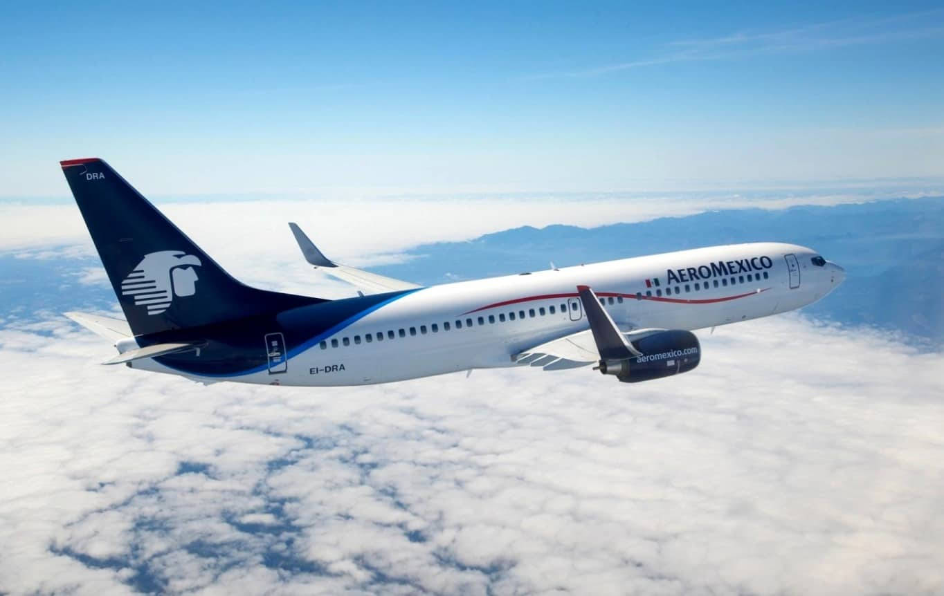 Aeromexico Boeing 737-800 Flying Over Clouds Background