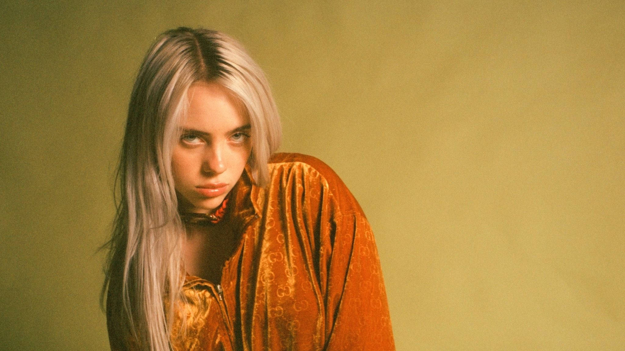 Aesthetic Billie Eilish In Orange Outfit Background