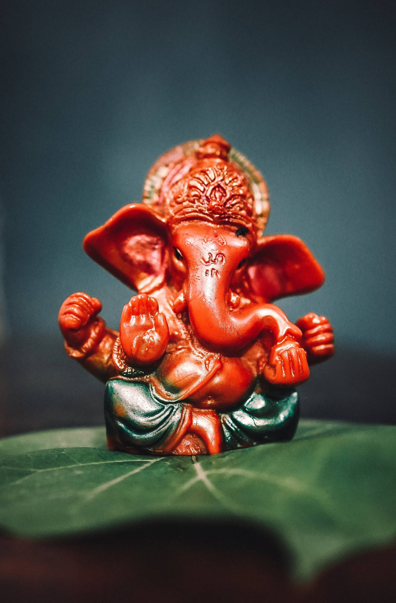 Aesthetic Ganesha Figurine In Red Background