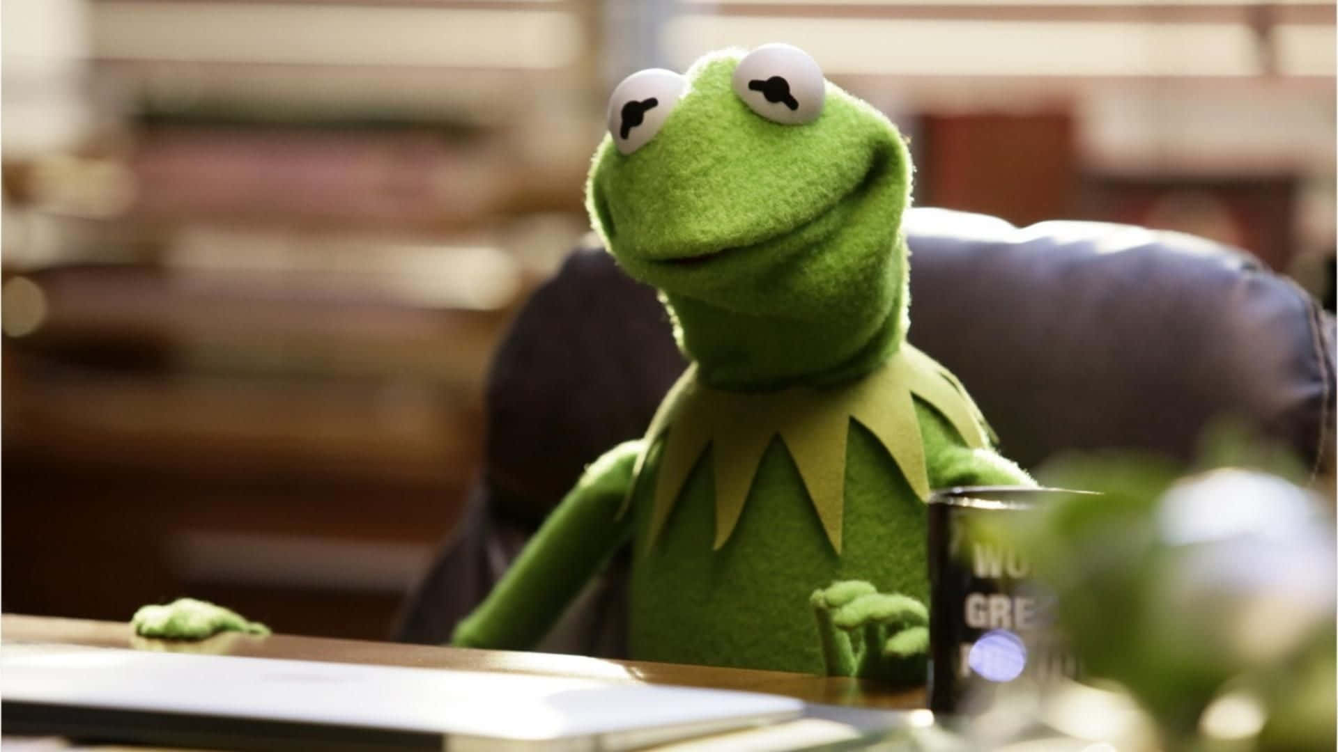 Aesthetic Kermit Sitting On Desk Background