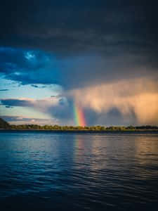 Aesthetic Rainbow Mobile Shrouded In Clouds Background