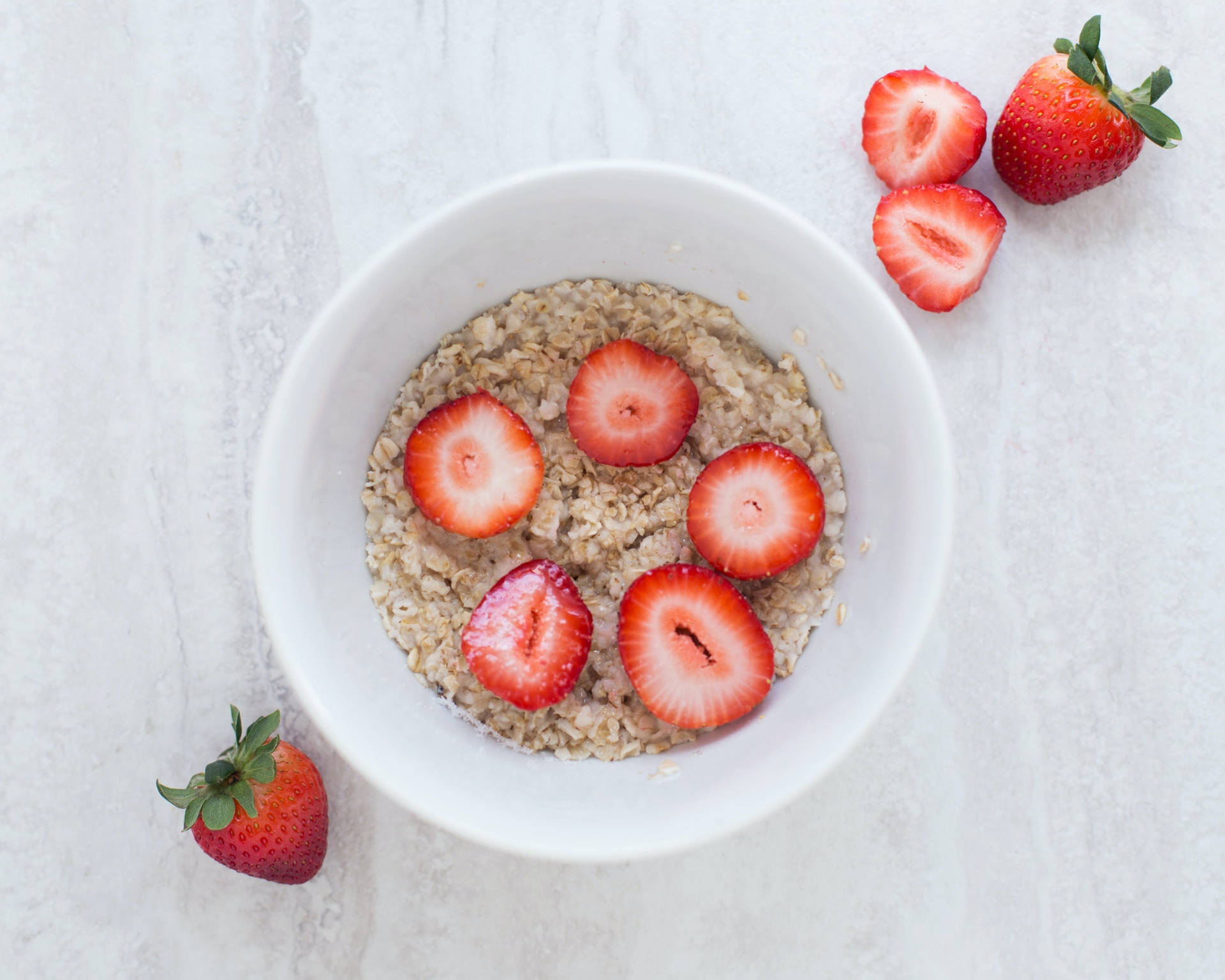 Aesthetic Strawberry Slices On Oatmeal Background