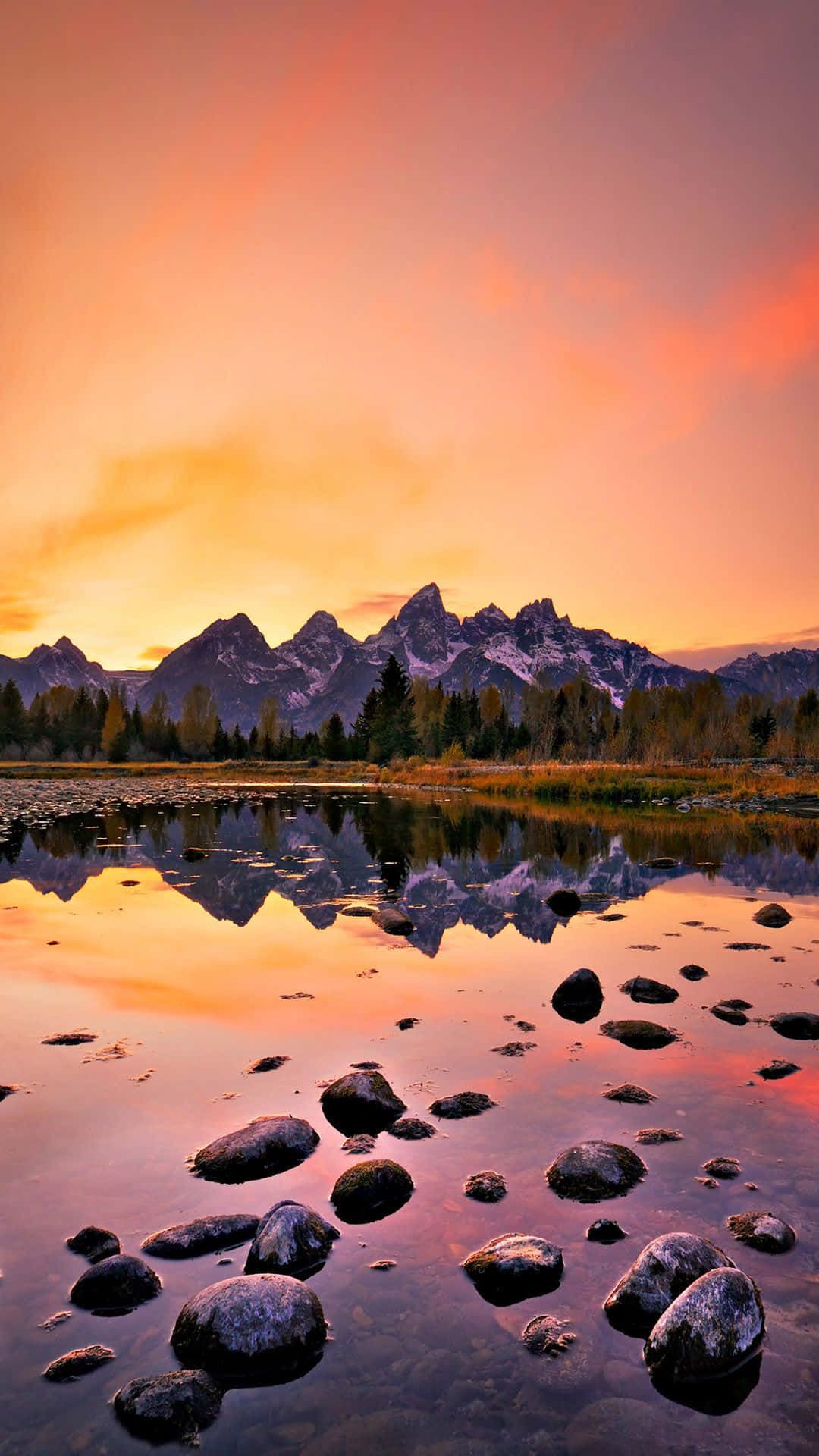 Aesthetic Sunset Iphone With Mountains And Forest Reflecting On Lake Background