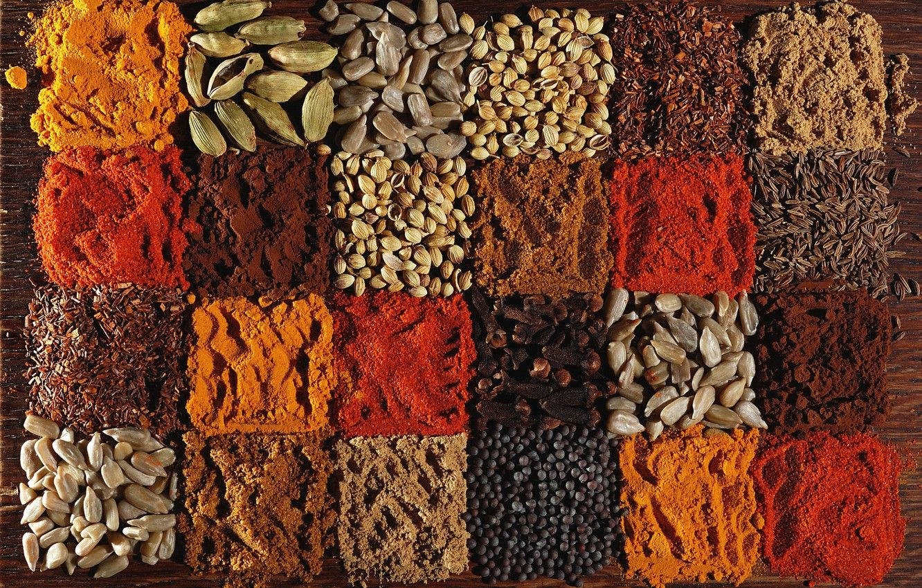 Aesthetically Displayed Collection Of Indian Spices With A Focus On Turmeric