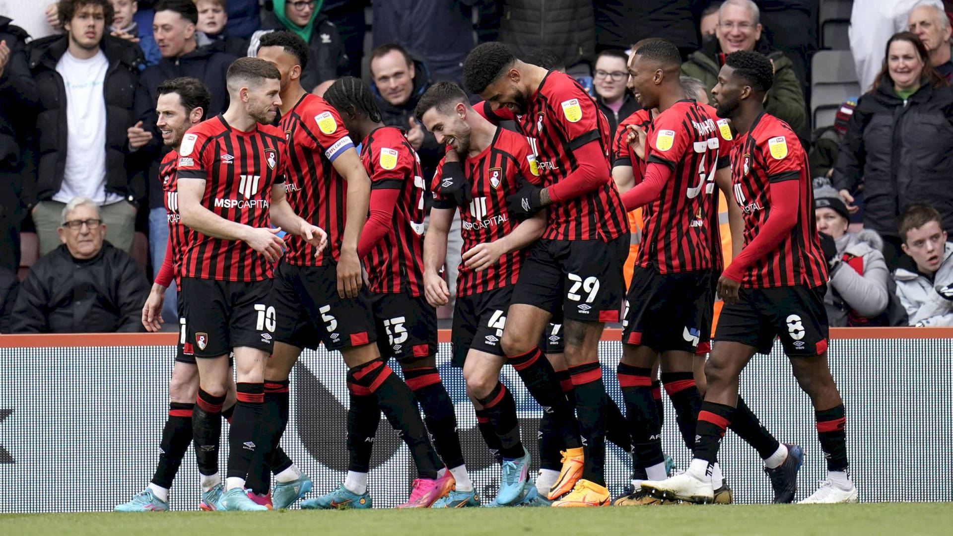 Afc Bournemouth Players Laughing Inside Stadium Background