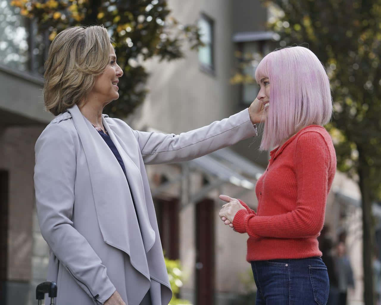 Affectionate Gesture Between Two Women Outdoors Background