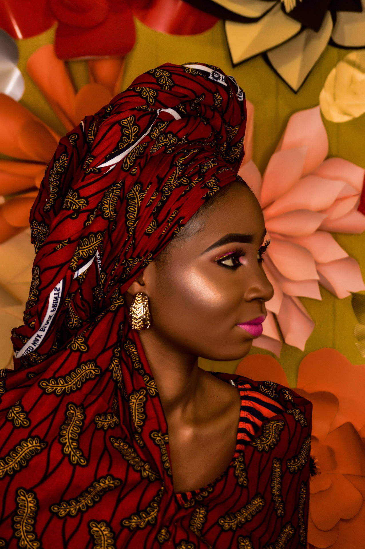 African Black Woman In Red Floral Headwrap Background