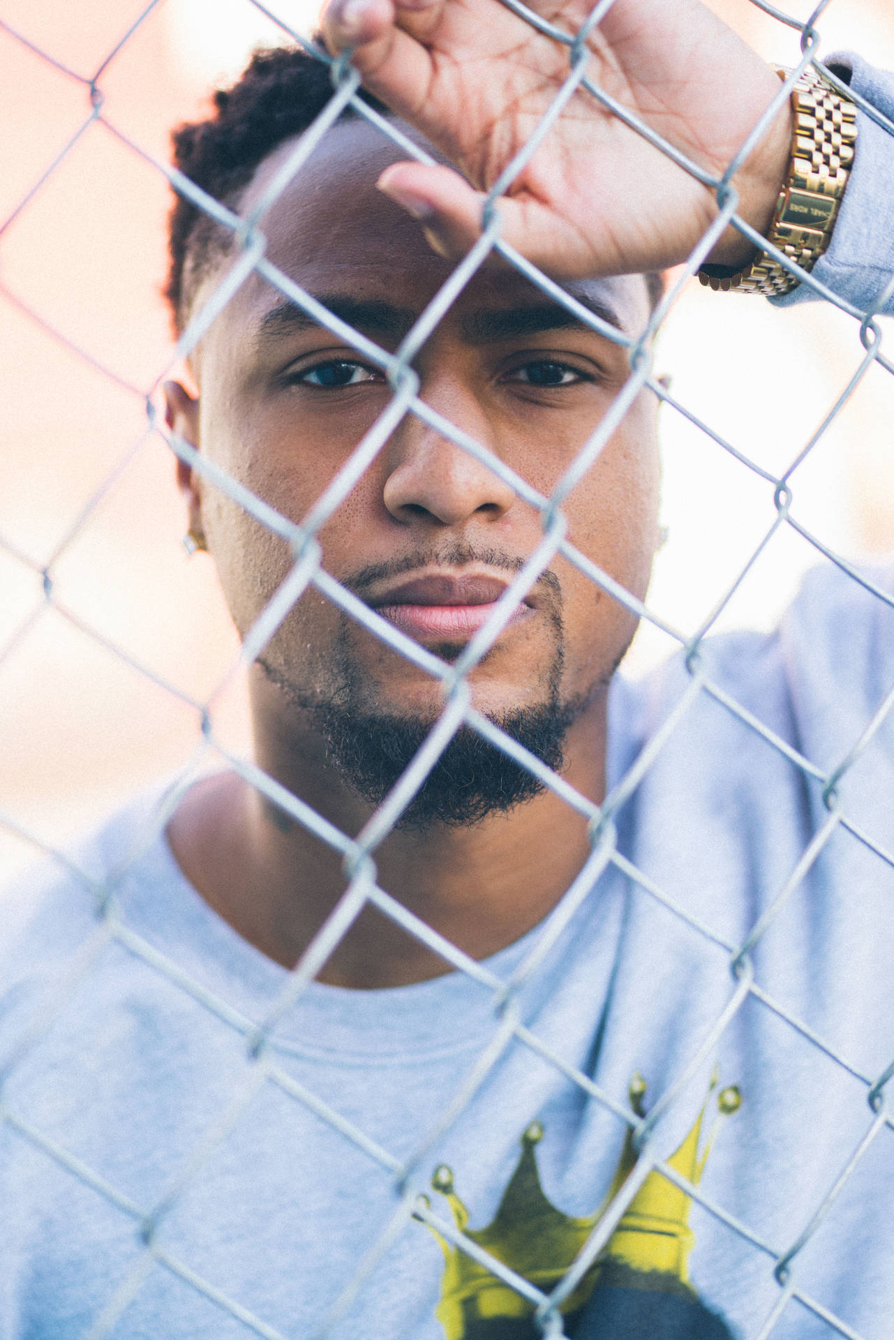 African Man Leaning On Fence Background