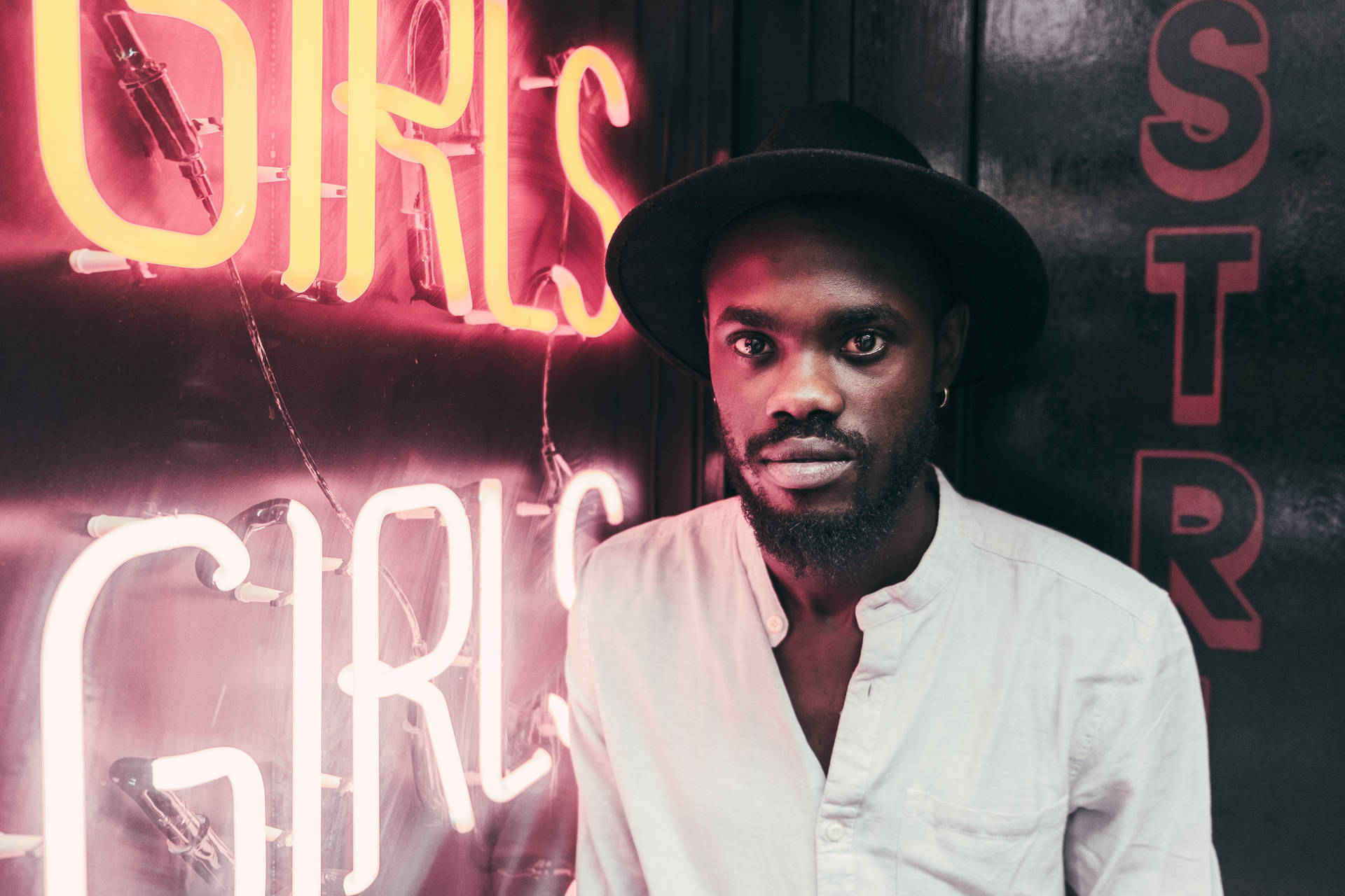 African Man Standing Beside Led Signage