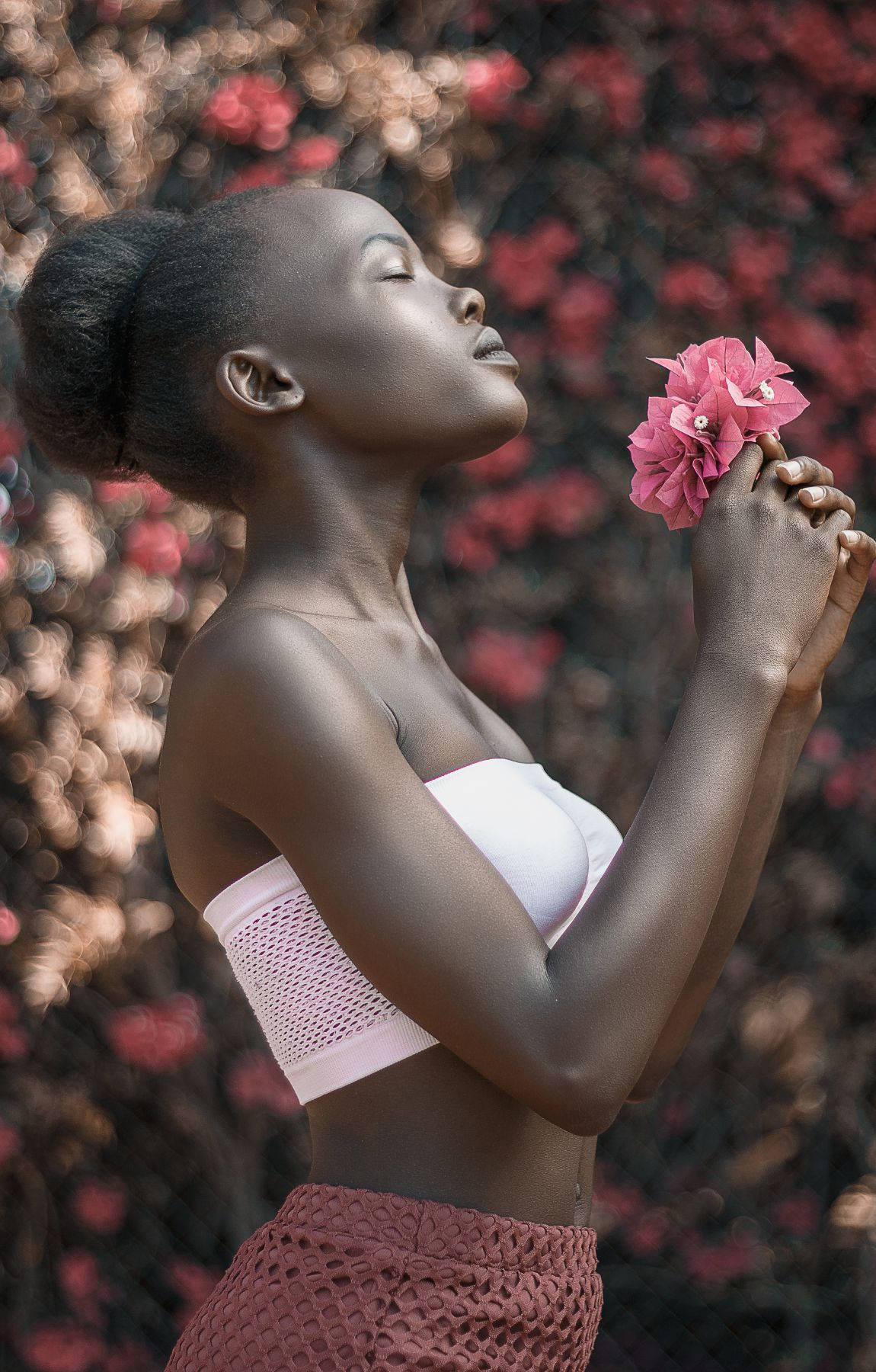 African Woman Holding A Pink Flower Background