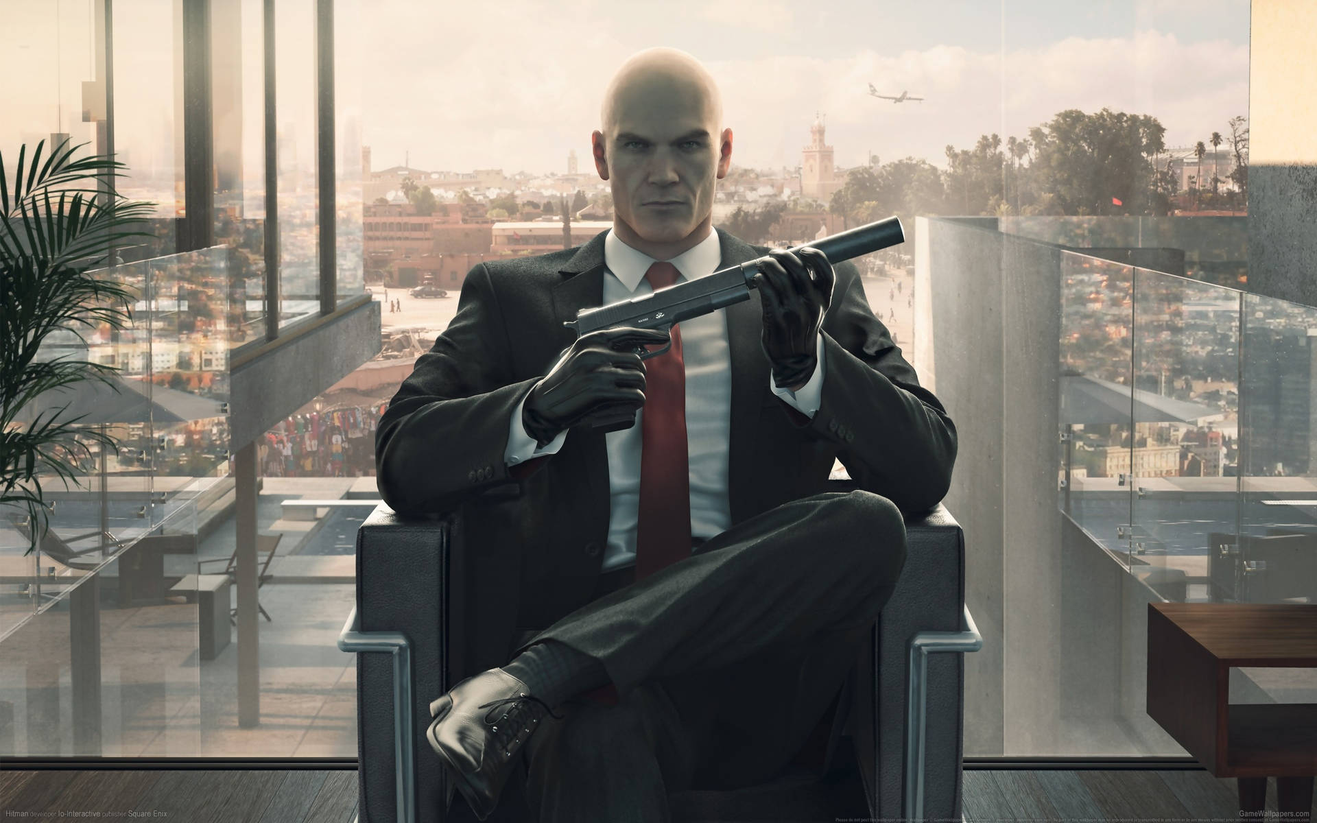 Agent 47 From The Hitman Series In A Black Suit Background