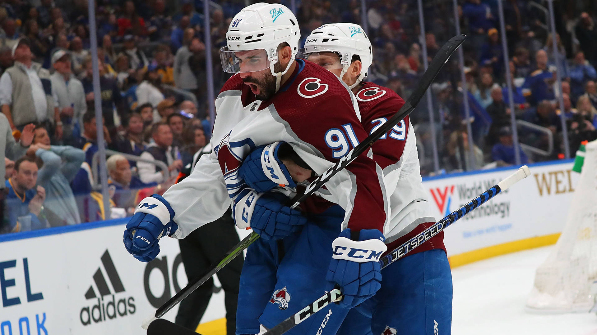 Aggressive Passion - Nazem Kadri Held Back By Teammate During A Heated Game Moment.