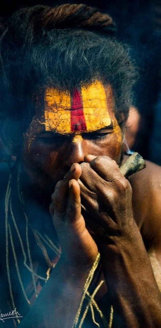 Aghori Lighting Up A Smoke Background