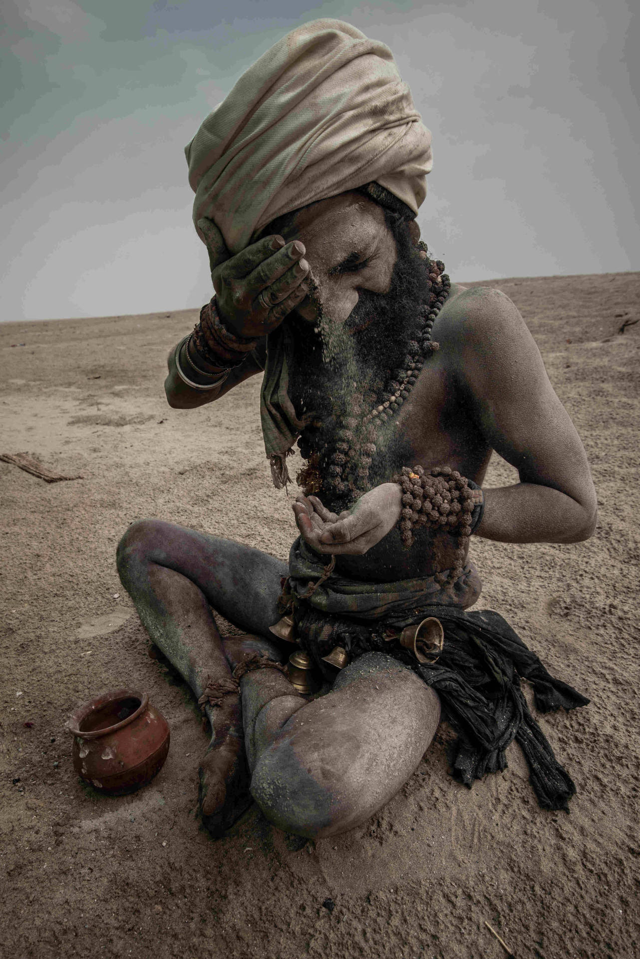 Aghori Painting Himself With Ashes Background