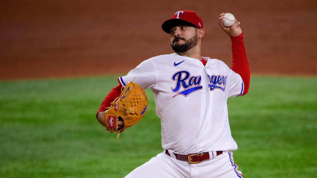 Agile Martin Perez In Mid-action On The Baseball Field Background