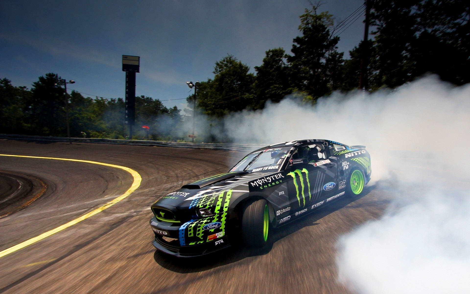 Agile Monster Drift Car In High-velocity Action Background