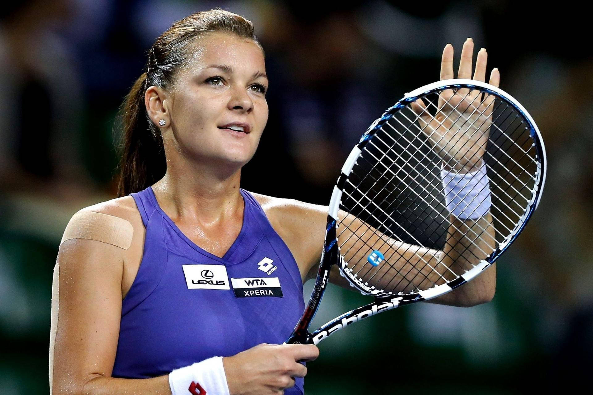 Agnieszka Radwanska In Action With Her Racket During A Tennis Match. Background