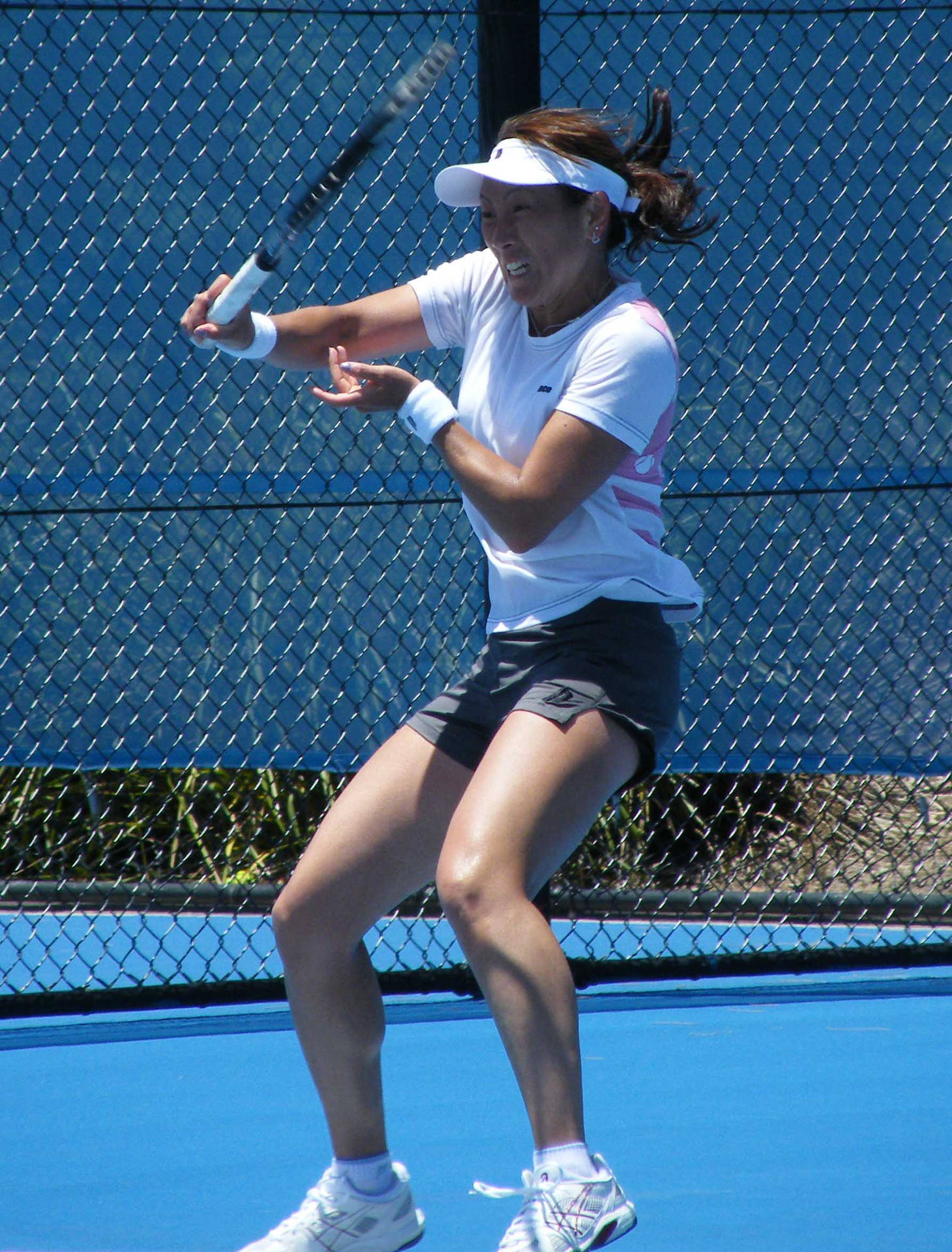 Ai Sugiyama Firing Off A Powerful Tennis Shot. Background