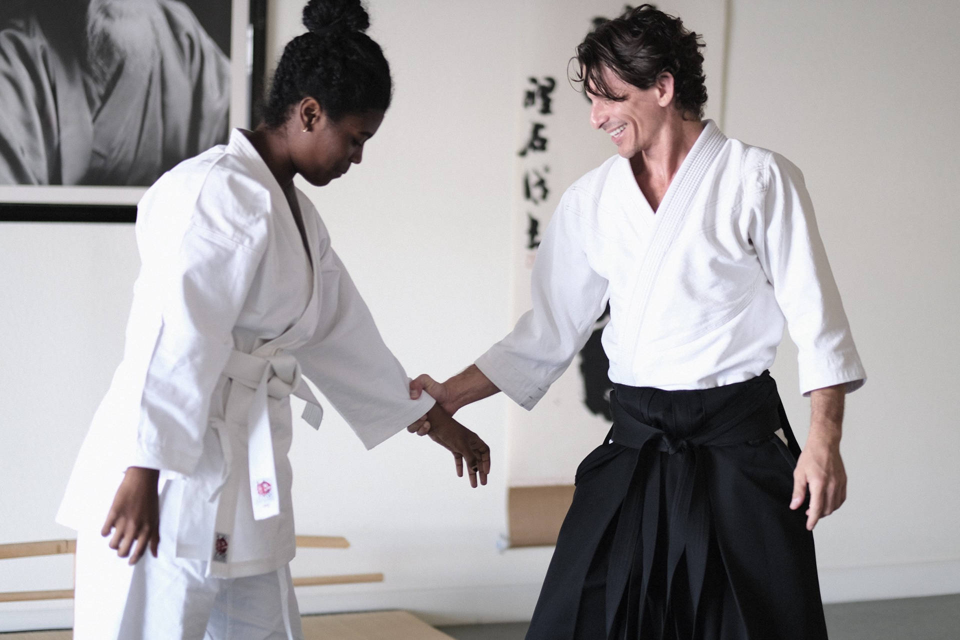 Aikido Sensei In Dojo Teaching Traditional Techniques Background