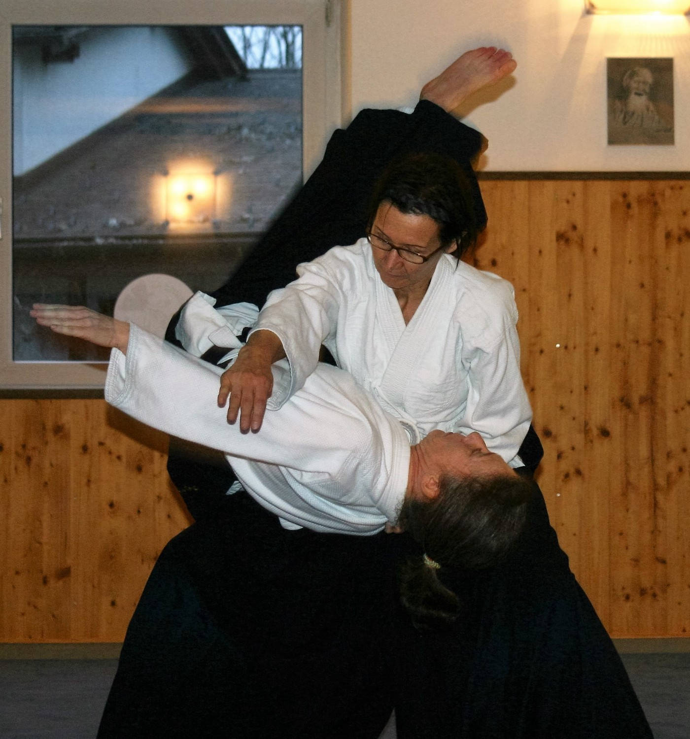 Aikidoka Performing Koshi Nage Aikido Technique Background