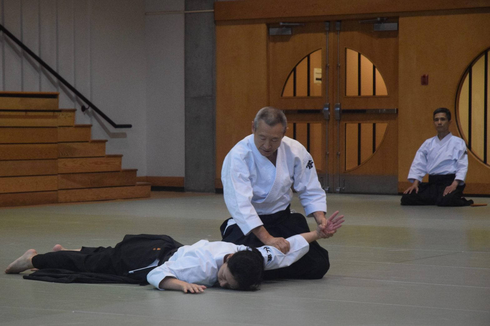 Aikidoka Performing Nikyo Aikido Technique Background