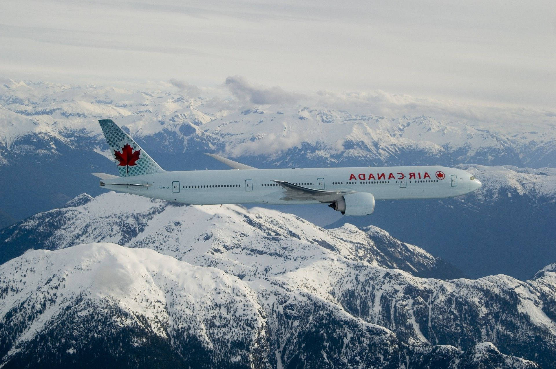 Air Canada Airplane Above Mountain Background