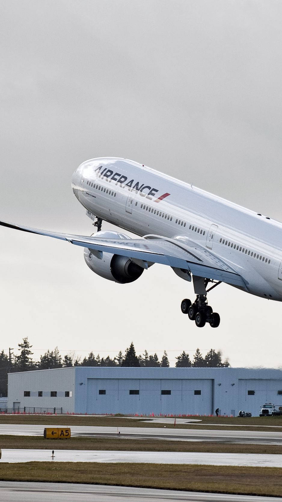 Air France Airline Boeing 777 Plane Above Ground Background