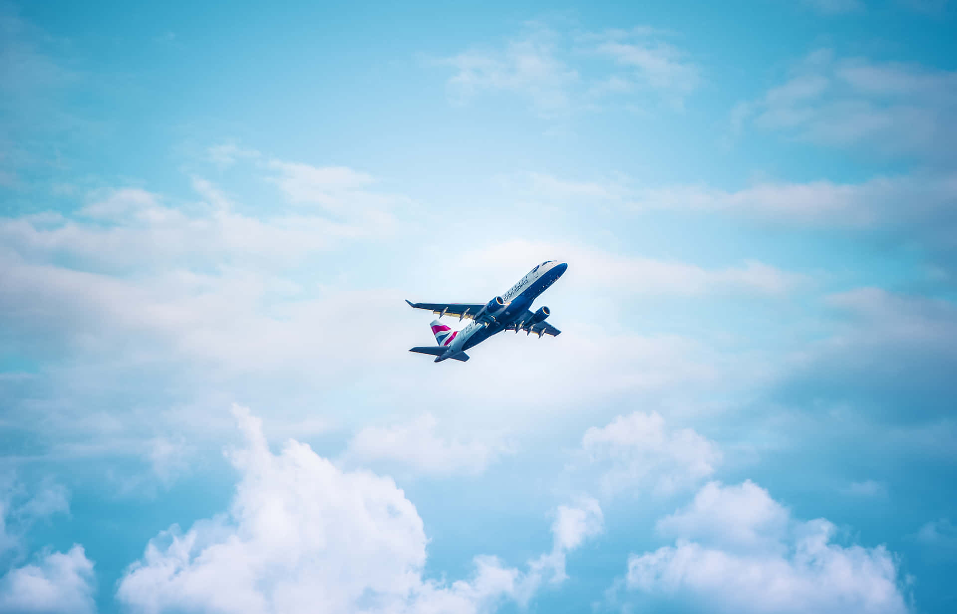 Airplane Ascending Against Blue Sky Background