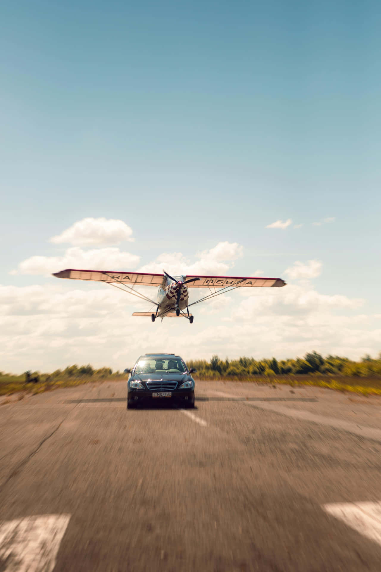 Airplane Landing Above Car