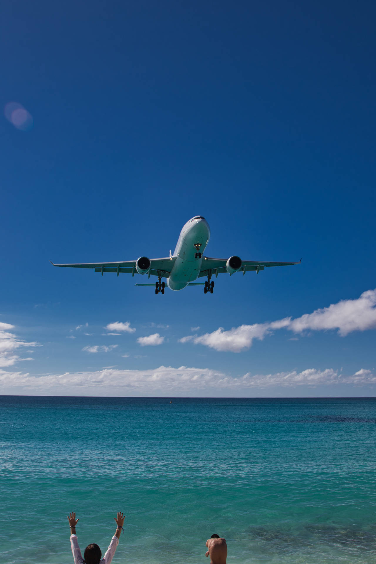 Airplane Passing Through The Beach At Sint Maarten Background