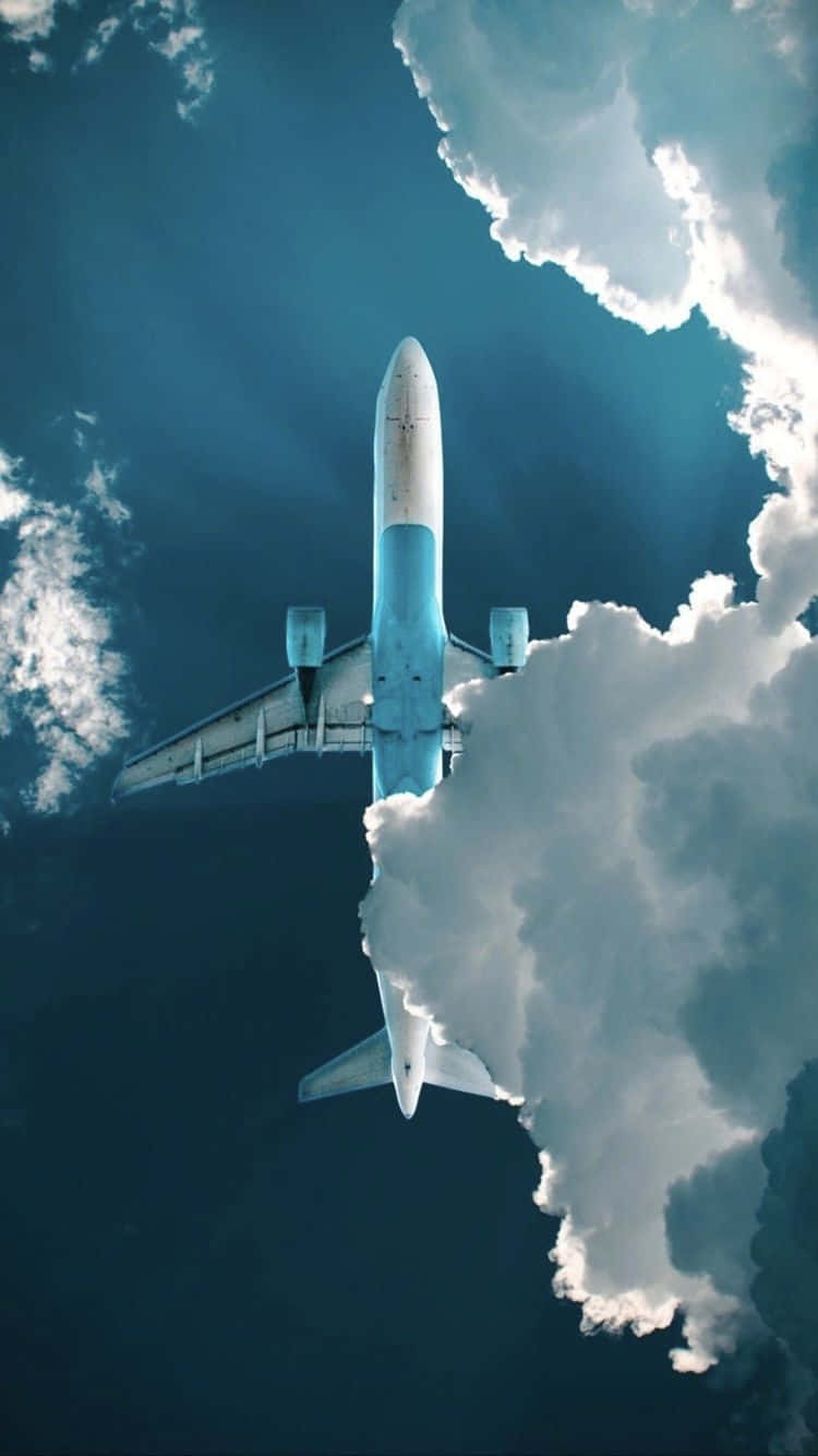 Airplane_ Soaring_ Above_ Clouds.jpg Background