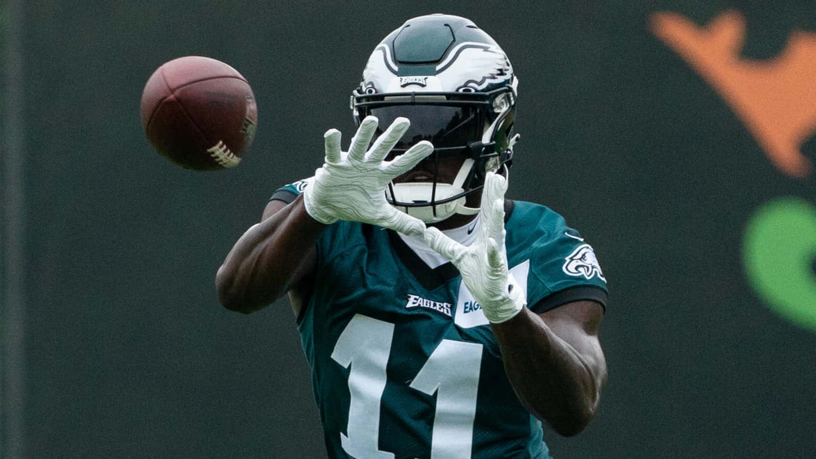Aj Brown Catching The Football Background