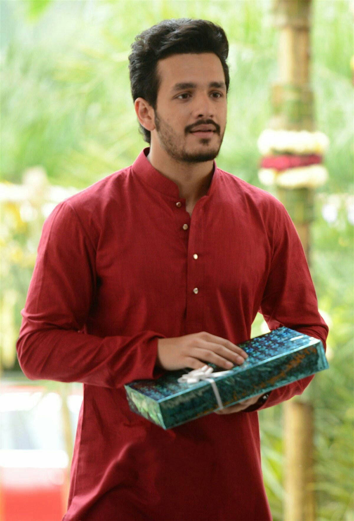 Akhil Akkineni Posing With A Gift Background