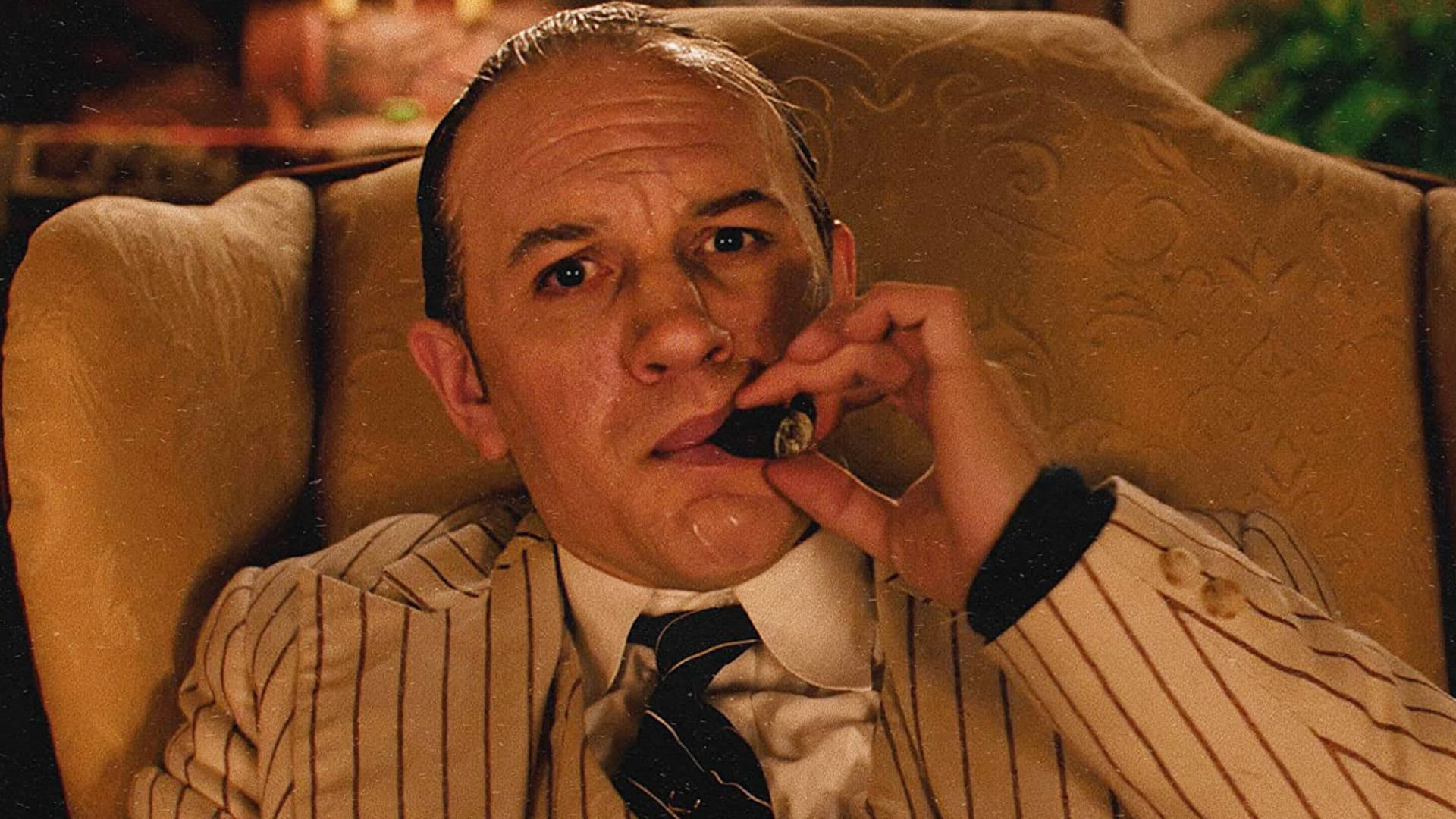 Al Capone With Tobacco On Sofa Background