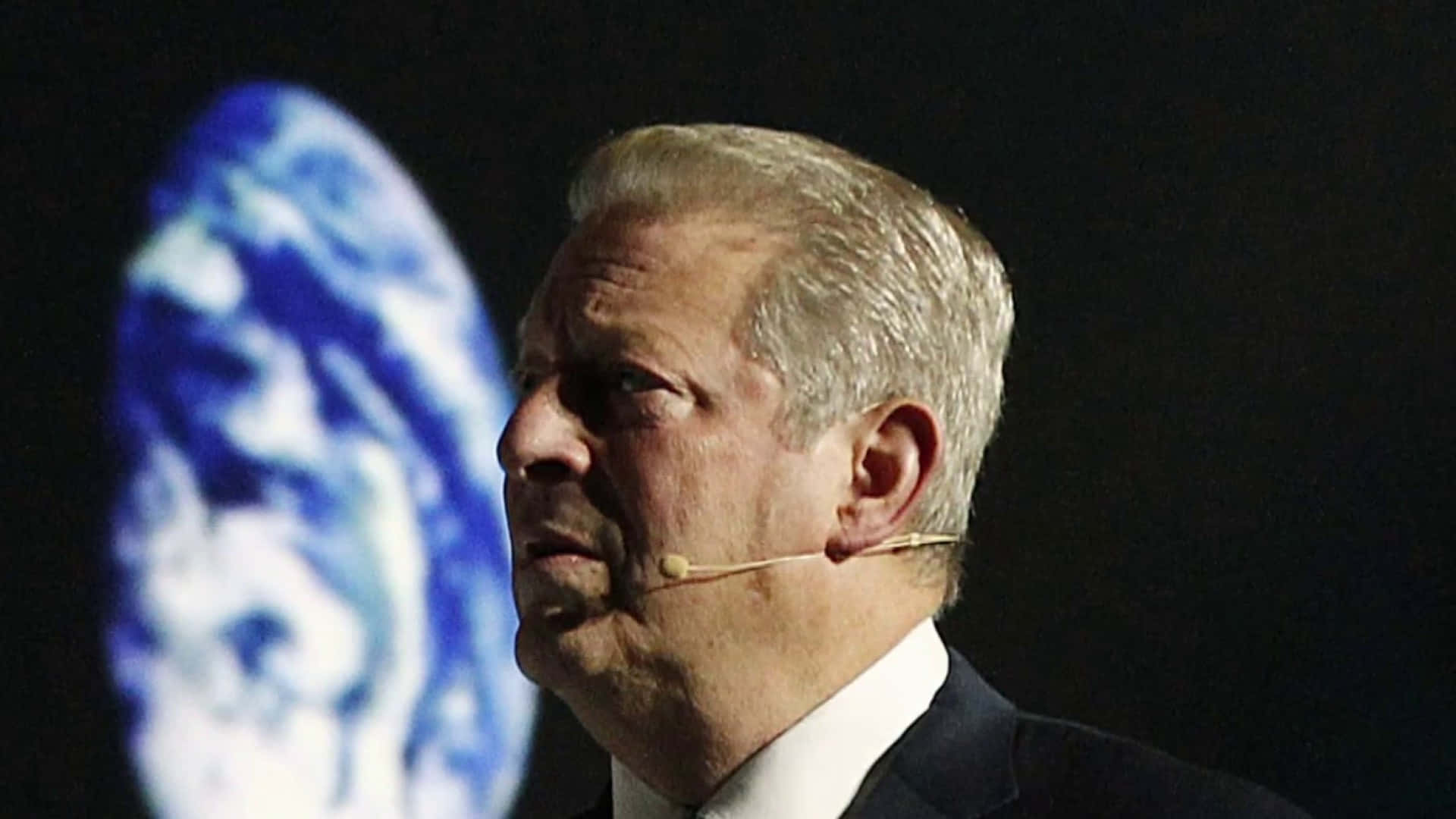 Al Gore Standing With Picture Of Earth Background