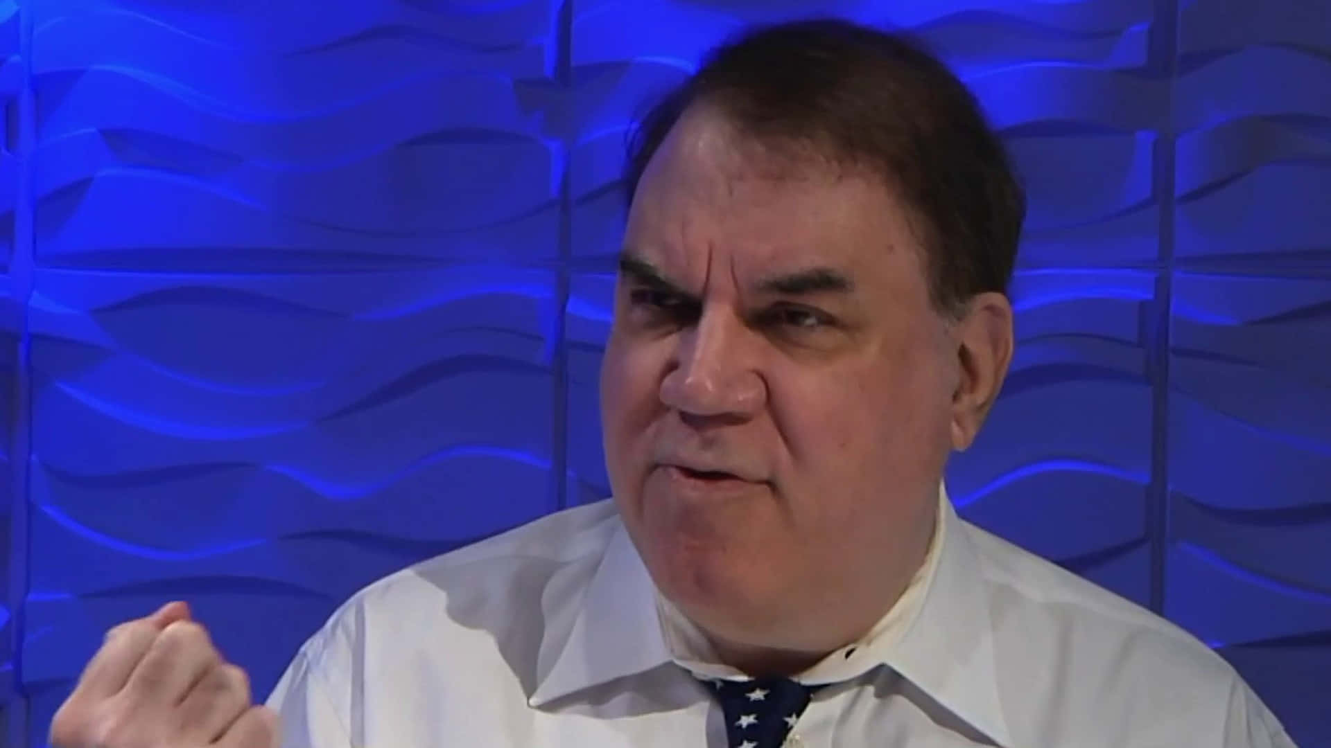 Alan Grayson Against Purple Backdrop Background