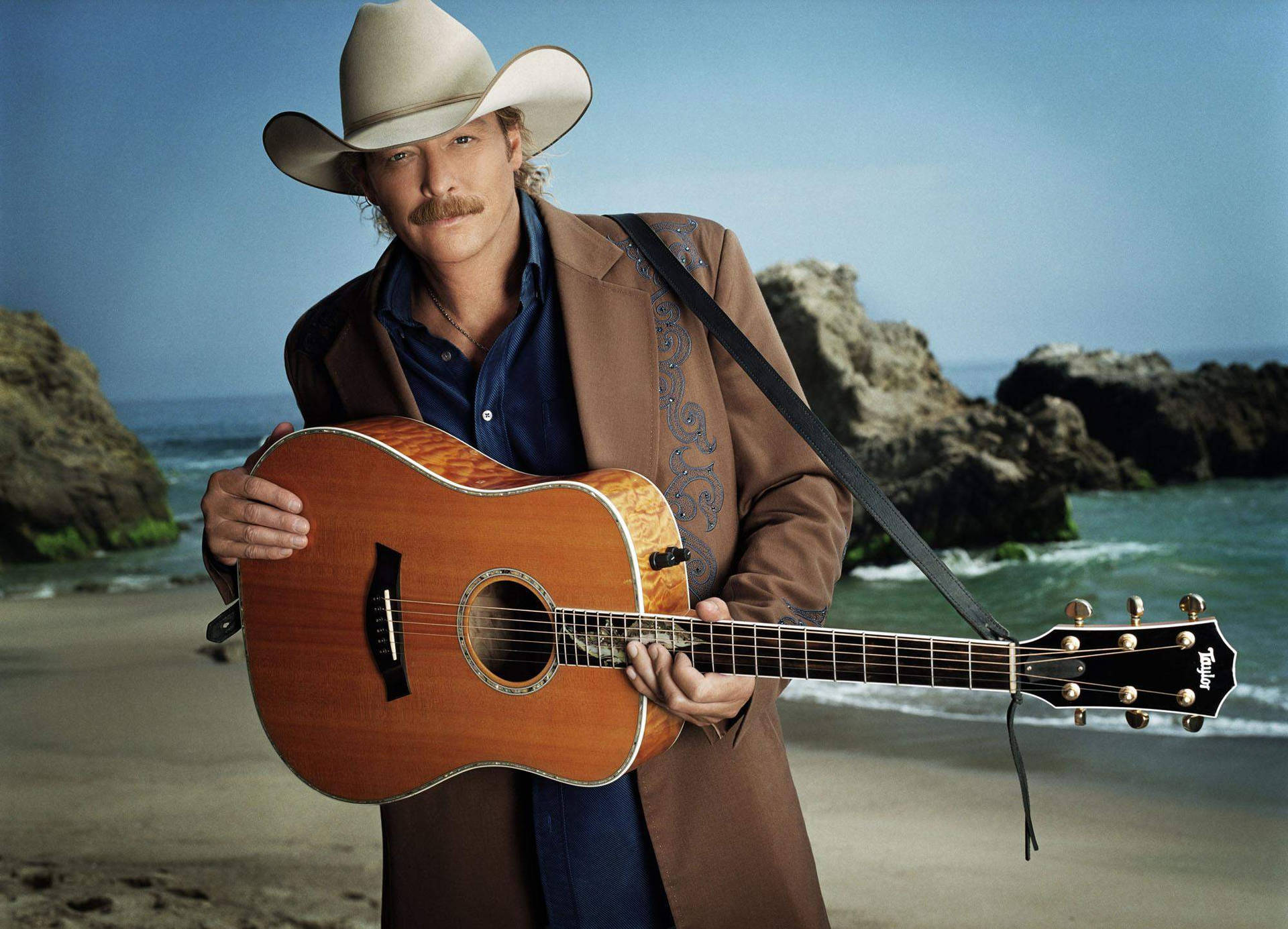 Alan Jackson By A Rocky Beach Background