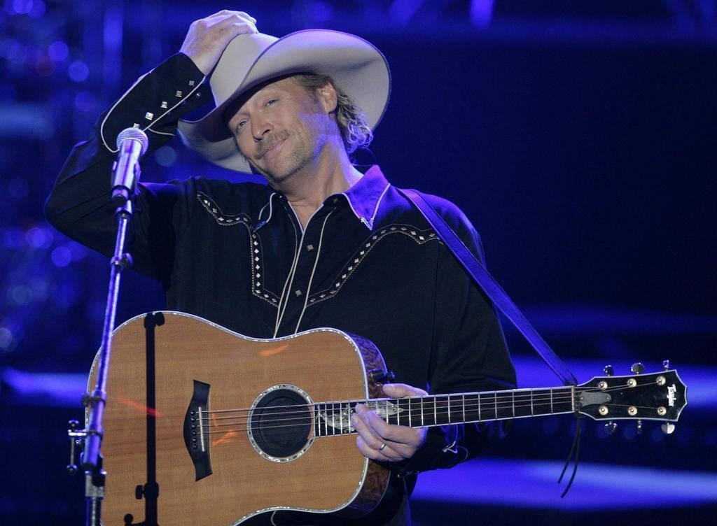 Alan Jackson With Blue Stage Light Background