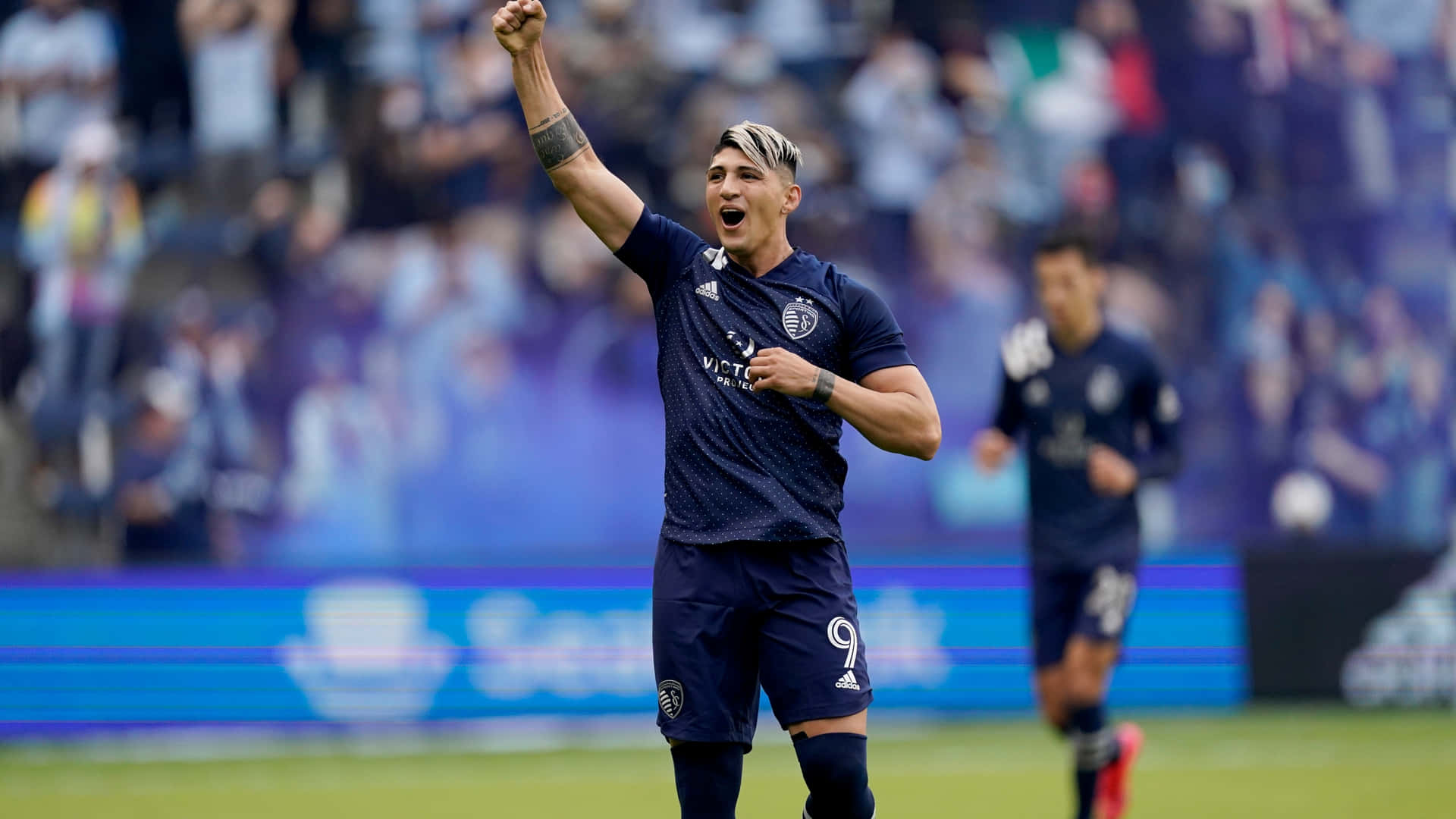 Alan Pulido Celebrating With Fist Up Background