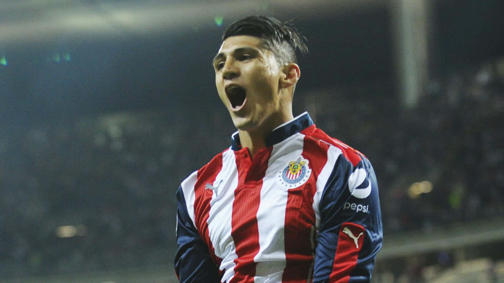 Alan Pulido In A Puma And Pepsi Sponsored Uniform Background