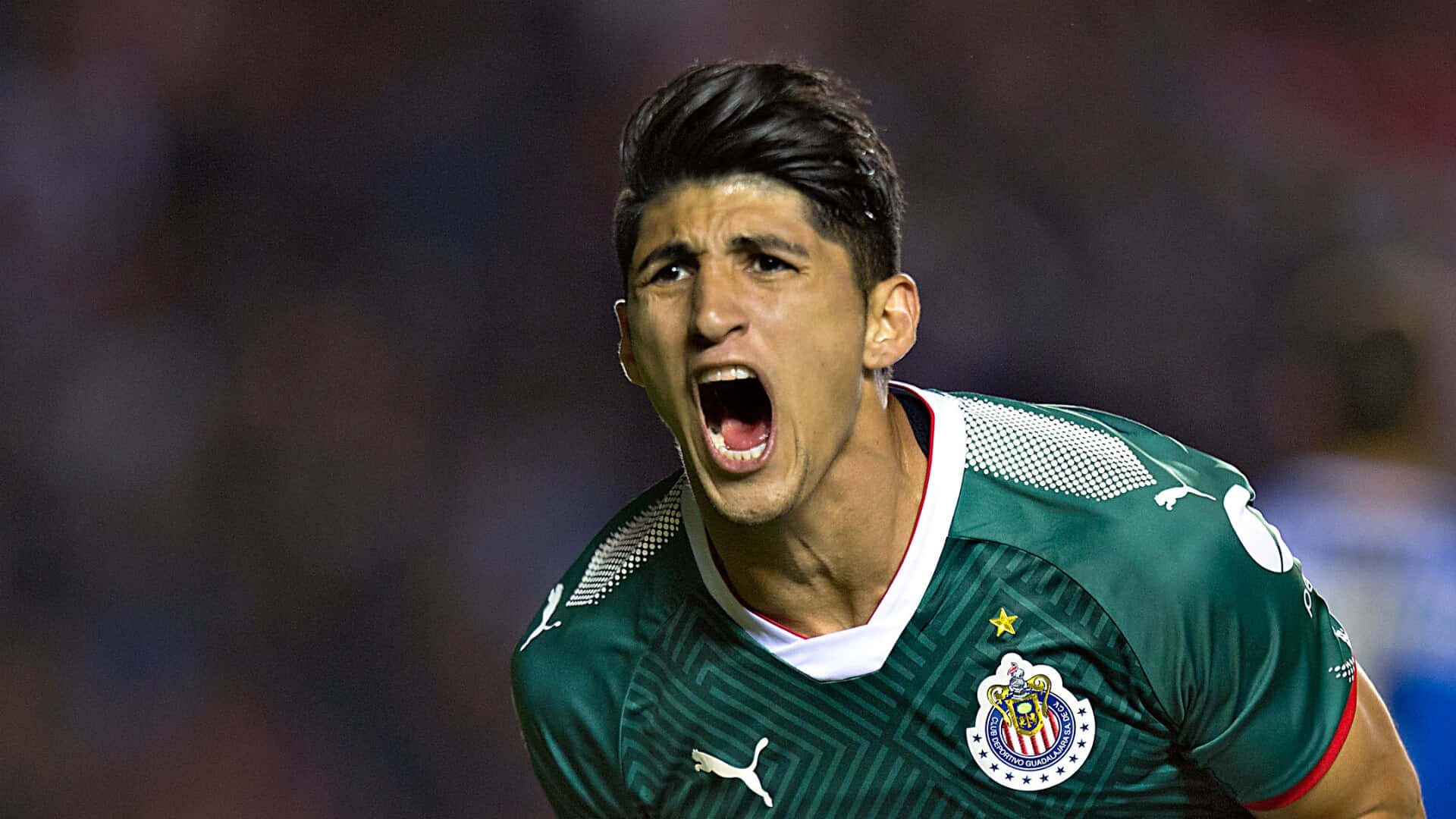 Alan Pulido In A Puma Chivas Guadalajara Uniform Background